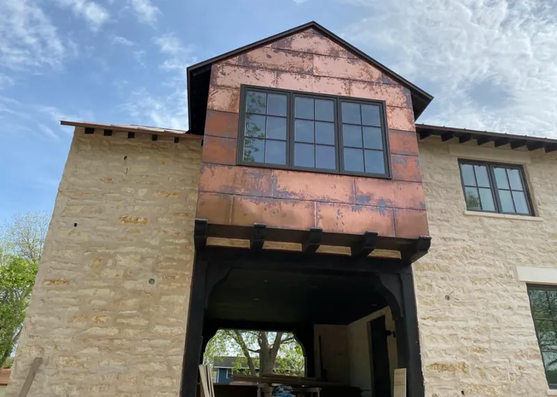 Copper metal panel facade on a stone building for Roof Repair in Ridgeland