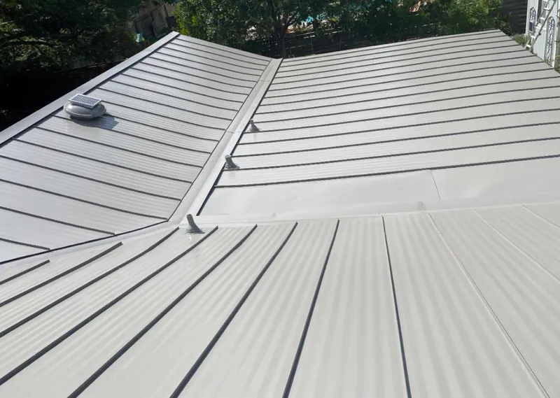 Solar attic fan installed on a metal roof for Roof Ventilation in Ridgeland